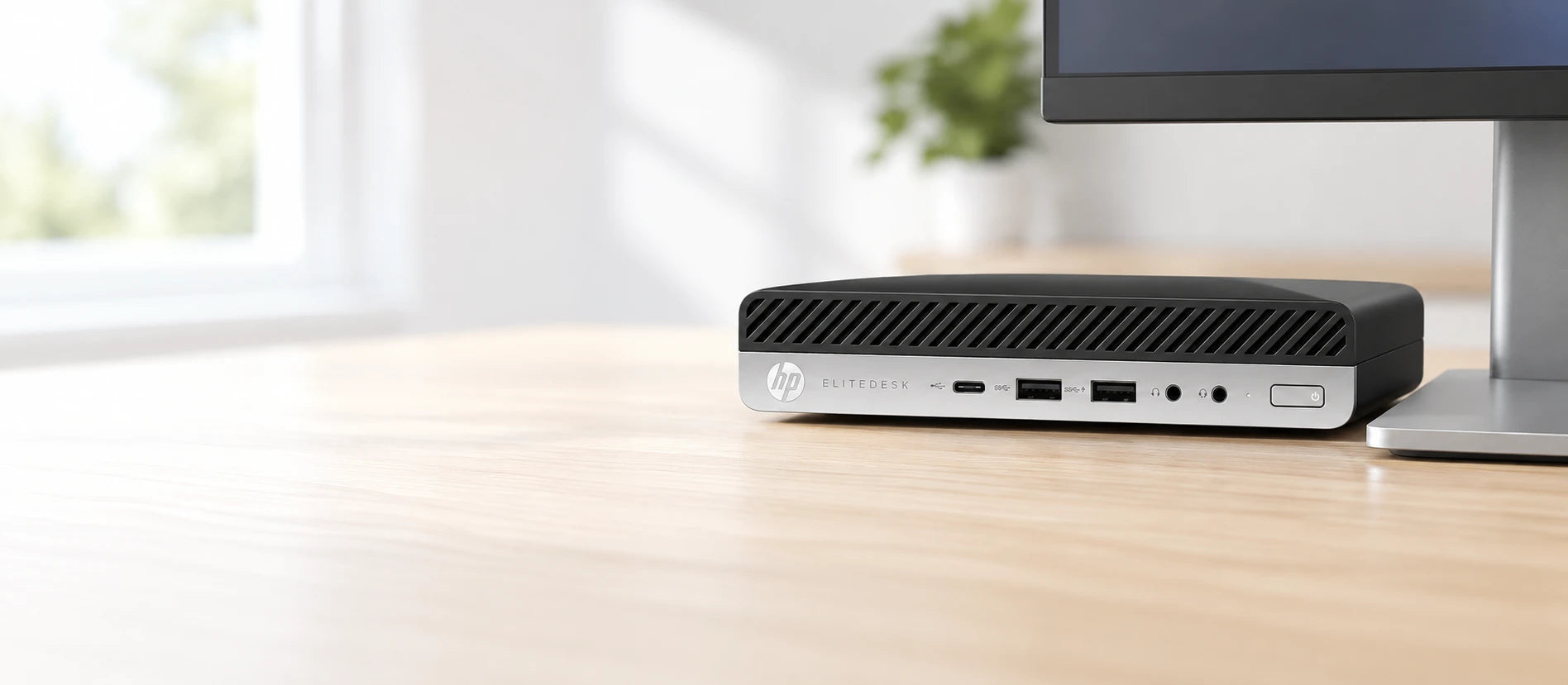 HP EliteDesk 800 G4 Mini desktop PC on a desk behind a monitor